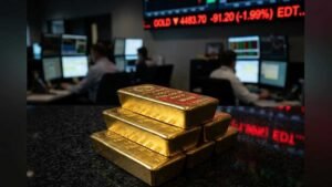 A cinematic landscape shot of gold bars on a dark reflective surface with a red declining market line in the background.